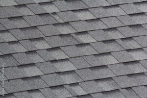 Close-up of new roofing shingles indicating roof replacement.
