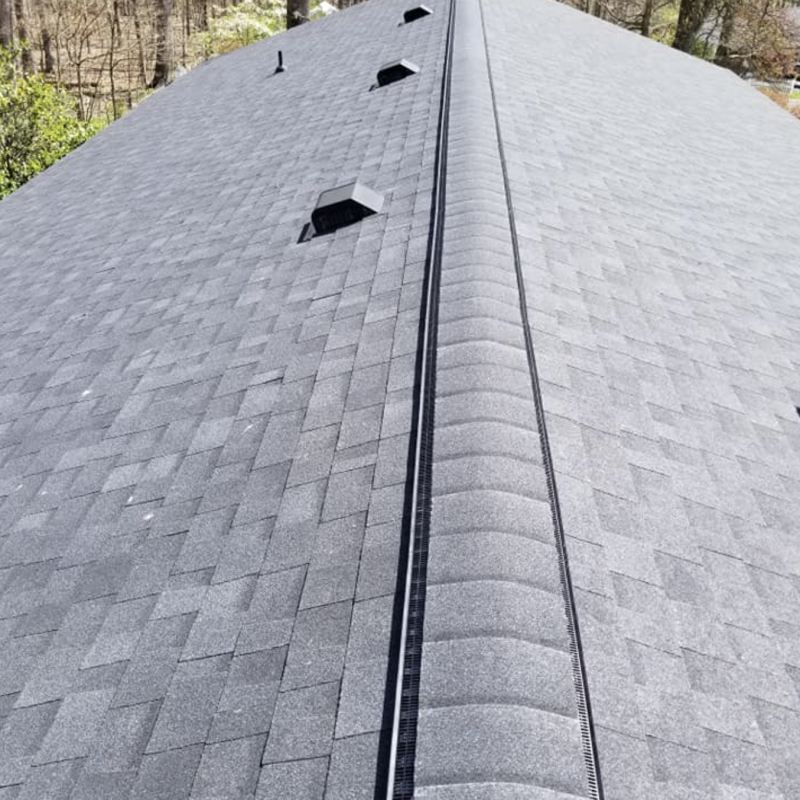 Complete roof installation by Appalachian Contractors, featuring new shingles, underlayment, and ridge vent.